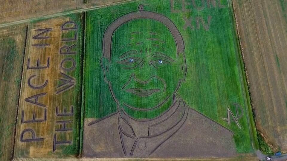 Artist draws portrait of Pope Leo XIV using a tractor on a field in Italy