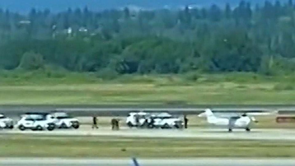 Watch police move to arrest pilot of a small 'hijacked' plane at Vancouver airport